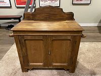 Front view showing double doors, backsplash, bracket feet
