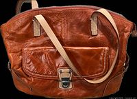 Front view of brown leather handbag with front pocket, clasp and strap visible