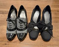 Both pairs of shoes side by side on floor