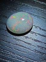 Top view of oval Ethiopian opal showing play-of-colour