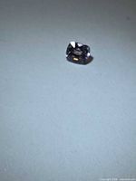 Loose cushion-cut light purple gemstone on white background