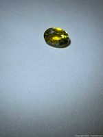 Top view of oval yellow sapphire showing color and cut