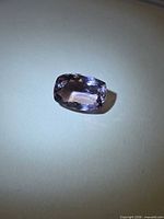 Rectangular cushion-cut ametrine on neutral background