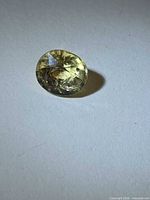 Front view of oval-cut scapolite gemstone