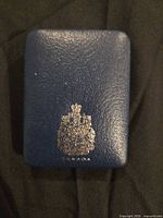 Blue leatherette presentation box exterior with Canadian coat of arms