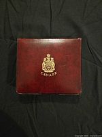 Closed burgundy presentation case with Canada crest