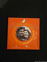 Front of orange presentation folder showing Canada-Netherlands 60 jaar bevrijding graphics