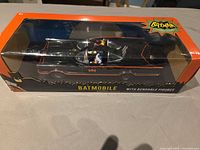 Front view of boxed Batmobile and figures