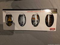 Boxed set front showing four character glasses through windows