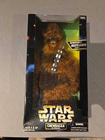 Front view of boxed Chewbacca figure showing window, bandolier and restraints