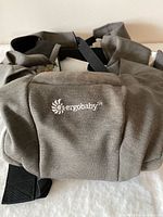 Front view showing Ergobaby logo and grey fabric