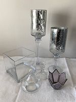 All six glass candle decor pieces grouped together
