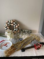 Grouping of all holiday items showing wreath, plate, garlands, ornaments, stocking holder and flowers