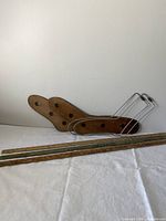 Wooden and metal sock stretchers with three wooden yardsticks