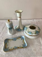 Full dresser set front view showing all four matching porcelain pieces