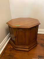 Closed view of solid maple octagon drum table showing door and knob