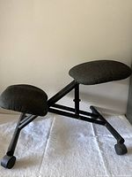 Full view of kneeling chair showing cushions and frame