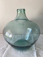 Full view of green glass jar showing shape and color