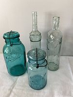 Two Ball jars and two bottles grouped