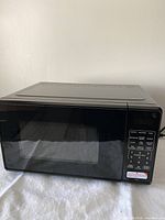 Front view of black digital Mainstays microwave