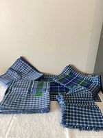 All linens laid out: two tablecloths, placemats, napkins