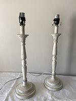 Front view of the two matching distressed white lamp bases showing overall design and height