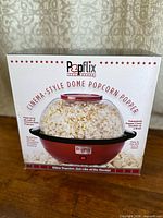 Front of retail box showing Popflix cinema-style dome popcorn popper