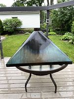 Front view of pyramidal copper hood on patio table
