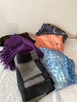 Group view of six scarves showing colours and patterns