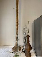 Group view: tall wooden floor lamp, glass, metal and wood table lamp bases