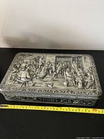 Top view showing full embossed tavern scene and size reference