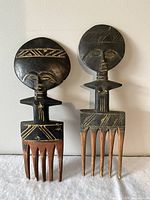 Front view of both carved wooden combs