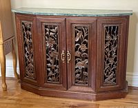 Front view showing carved panels, hardware, overall cabinet shape