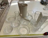 Group view of all porcelain, crystal and glass pieces with measuring tape