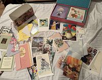Open box showing assortment of greeting cards spread out with envelopes