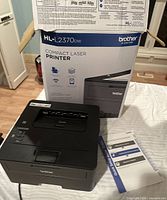 Printer with manual and box visible