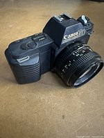 Front angled view of Canon T50 with FD 50 mm lens attached