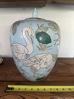 Front view showing cranes motif and lid