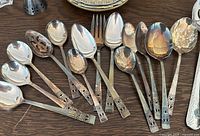 Group shot of all 16 Coronation pattern serving pieces