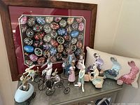 Overview of framed egg puzzle, sequin pillow and multiple bunny figurines on cabinet