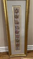 Full view of vertical gold-framed fruit garland print