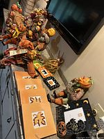 Entire assortment of pumpkin figurines, trivets, frame, dishes and wreath on countertop