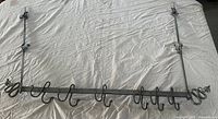 Full view of pot rack with hooks attached on cloth background