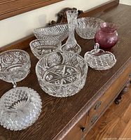 Group view of all nine glass pieces on dresser