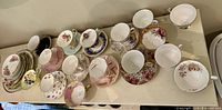 Top view of entire assortment on shelf showing cups and saucers layout