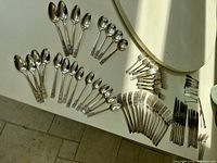 Full assortment of Coronation flatware spread out on table