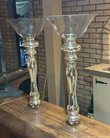 Both silver mercury glass vases standing side by side on counter