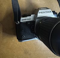 Front and left side of Pentax Super Program with attached lens and strap