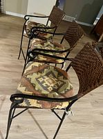 Side view of three matching bar stools showing frames, cushions and backs