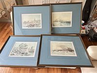 All four framed prints laid out showing mats and frames